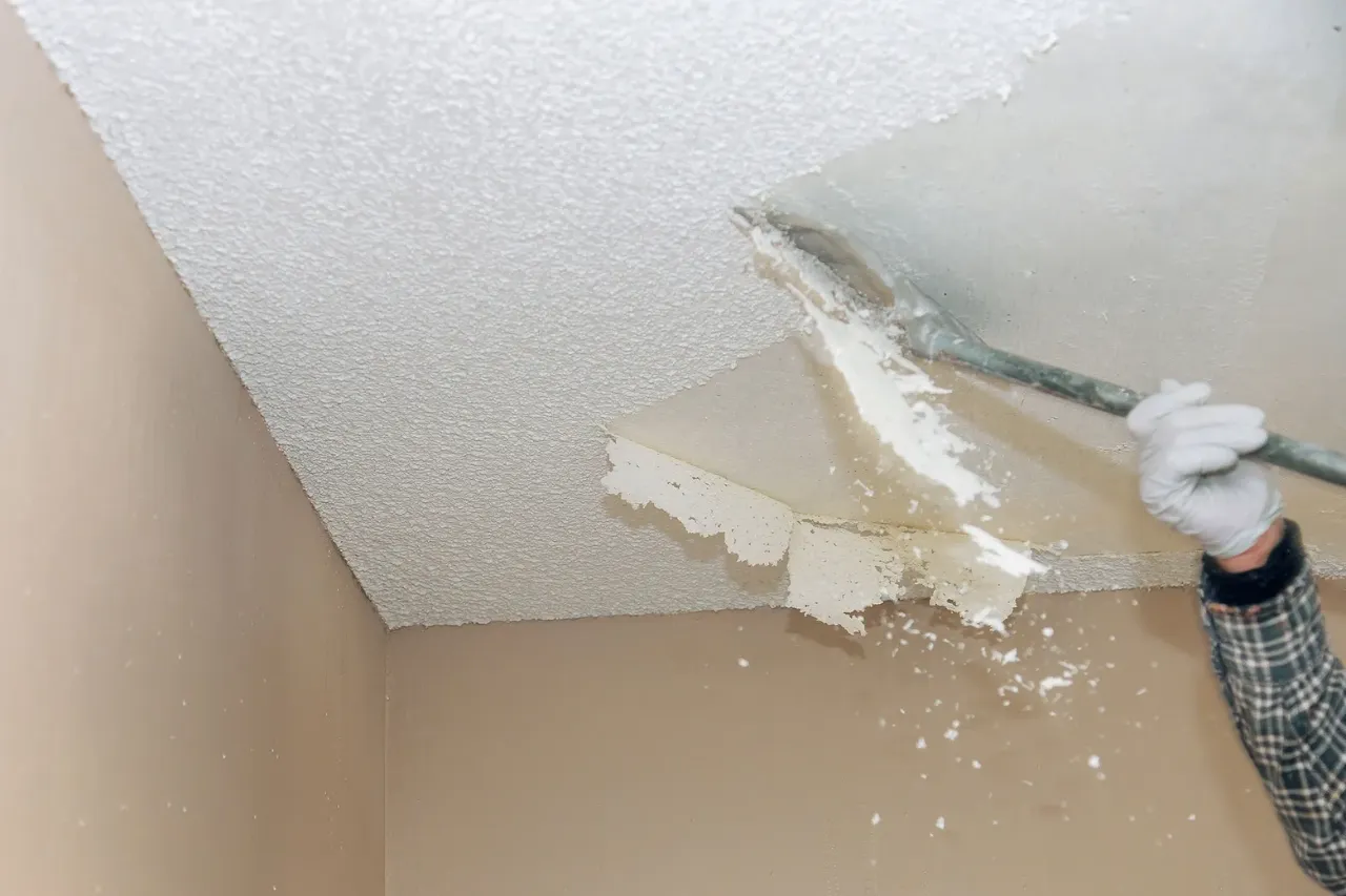 Room prepped with plastic sheeting before popcorn ceiling removal in Massachusetts