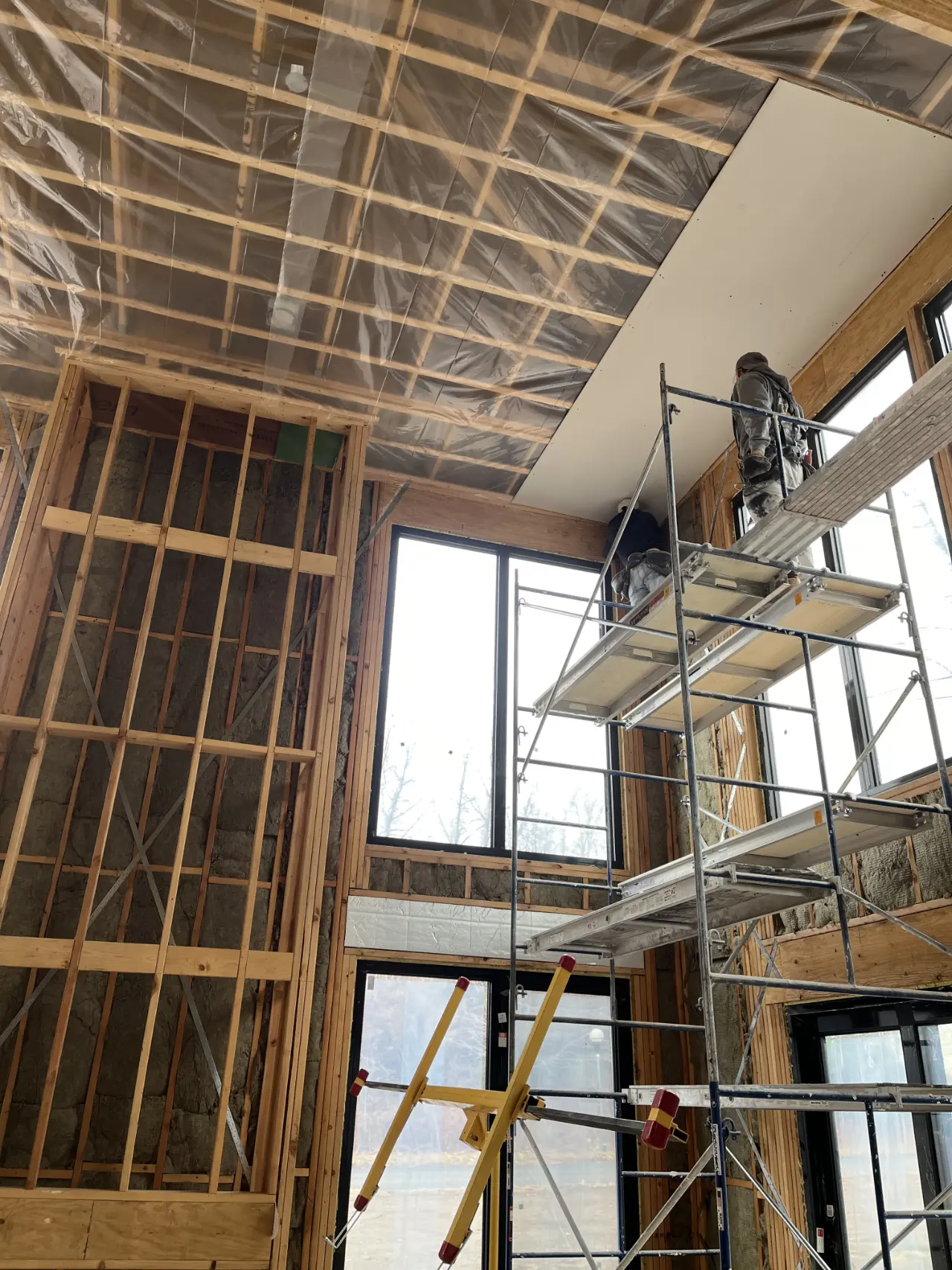 Drywall section being worked on at height in a Massachusetts home
